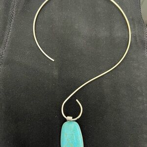 Elegant Silver Necklace with a blue stone accent.